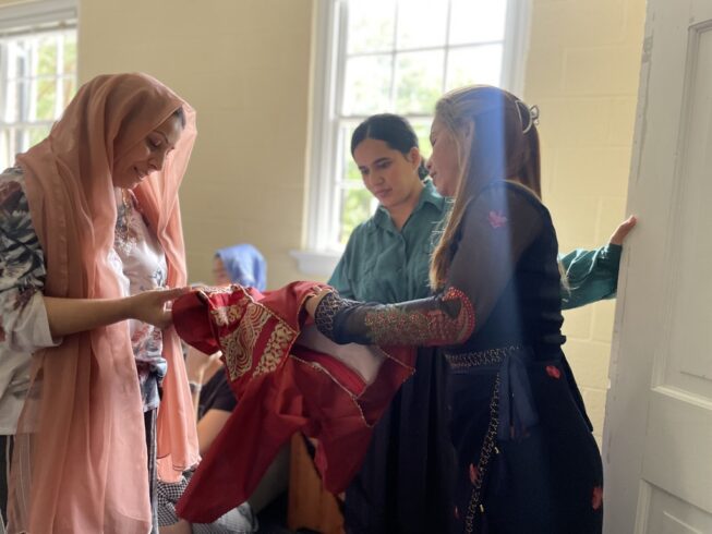 Khin, a refugee leader from Burma, joins our Afghan Women's sewing circle to provide guidance on starting your own business as a seamstress in the US. Refugee women empower refugee women!